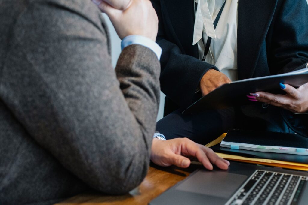 Two people reviewing a document across a desk
