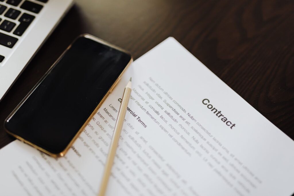 Contract paperwork and a pen on a desk